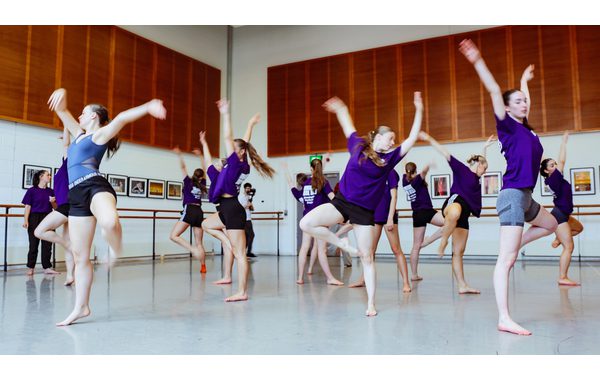 A group of students in a classical ballet pose.